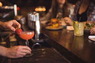 bartender-holding-cocktail-bar-counter