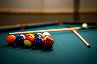 closeup-billiard-balls-sticks-table